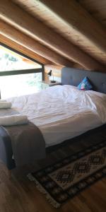 un letto grande in una stanza con soffitto in legno di Oasis Chalet a Lisnău