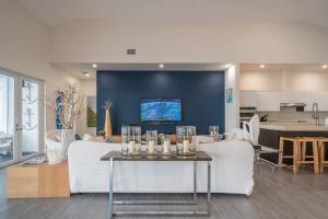 a living room with a couch and a table with candles at Bimini Breeze Villa in Bailey Town