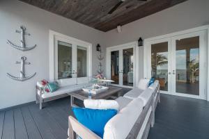 a living room with a couch and a table at Bimini Breeze Villa in Bailey Town