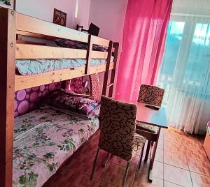 a room with a desk and a bunk bed and a table at Tanie Noclegi Krysia Falsztyn in Falsztyn
