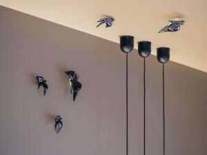 a wall with black birds hanging on a wall at Mercure Porto Centro Santa Catarina in Porto