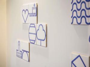 a white wall with some pictures on it at Mercure Porto Centro Santa Catarina in Porto