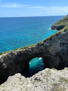 a cave in the rocks next to the ocean at Kataléa - Plage à moins de 2 minutes à pieds in Grand-Bourg