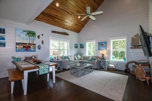 a living room with a couch and a ceiling fan at A Pura Vida in Edisto Island