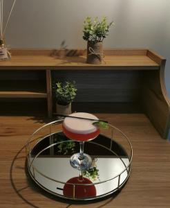 a stool sitting in front of a table with plants at Rooms at the Village in Omagh