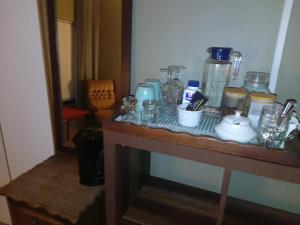 a table with many glass jars and bottles on it at Goose On Uitvlught Self Catering Accommodation Room2 in Montagu +11 photos