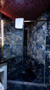 a bathroom with a blue wall with a towel at can palace adalya otel in Antalya