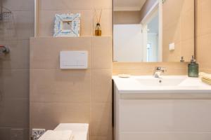 a bathroom with a sink and a mirror at Casa Alecrim in Tavira +47 photos