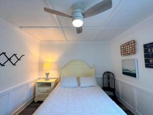 a bedroom with a bed with a ceiling fan at Serenity Now in Edisto Island
