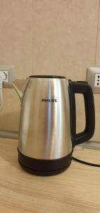 a metal tea kettle sitting on a table at Maya Suite & Garden in Sarteano +2 photos