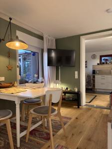 a kitchen and dining room with a table and chairs at Ferienwohnung Lahntalblick in Weilburg