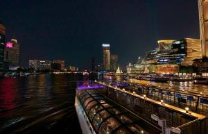 a view of a river with a city at night at Banyan Tree Bangkok in Bangkok