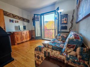Una sala de estar con un sofá y una ventana. en Confort excelente- Chimenea, sol y bien equipado - Falcó 10, en Pla de l'Ermita