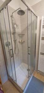 a shower with a glass enclosure in a bathroom at Maya Suite & Garden in Sarteano