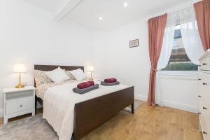 a bedroom with a bed with two pillows on it at Private Hot Tub - Garden - Free Parking -2bdrm - 5ppl - Zen & Bubbles in Edinburgh