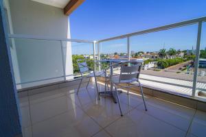 two chairs and a table on a balcony with a view at Garcia Palace Hotel in Sinop