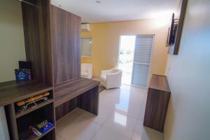 a room with a living room with a couch and a refrigerator at Garcia Palace Hotel in Sinop