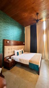 a bedroom with a large bed in a room at Avanee Hotel in Mawanella