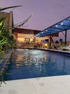 a large swimming pool in a building with a house at Quinta Los Castillos in Itá +8 photos