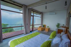 a bedroom with a large bed and a large window at The Ledge Ella in Ella +76 photos