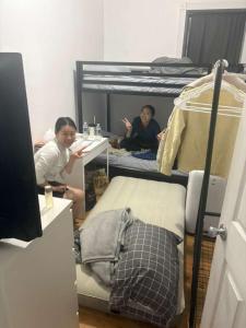 two girls sitting in a room with bunk beds at Central Park Northwest Corner - Harlem in New York