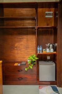 a kitchen with a large wooden cabinet with a sink at The Ledge Ella in Ella