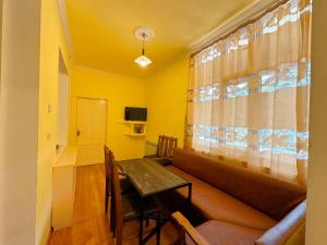 a living room with a couch and a table at Church-View Lodge by Green Garden, Dilijan in Dilijan