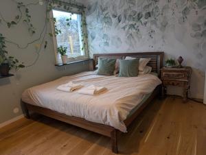 a bed with two towels on it in a bedroom at Home in Vingåker in Vingåker