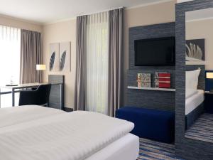 Ένα ή περισσότερα κρεβάτια σε δωμάτιο στο Mercure Hotel am Entenfang Hannover
