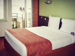 Postel nebo postele na pokoji v ubytování Mercure Strasbourg Centre Gare