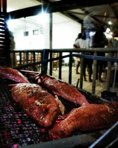 a group of meat cooking on a grill at Panoramic Paradise 2 in Marianne Island