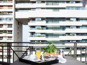 a table with food on a balcony with a building at Sofitel Beirut Le Gabriel in Beirut +132 photos