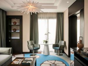 a living room with a couch and chairs and a table at Sofitel Beirut Le Gabriel in Beirut