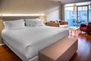 a large white bed in a hotel room at NH Collection Madrid Abascal in Madrid +57 photos