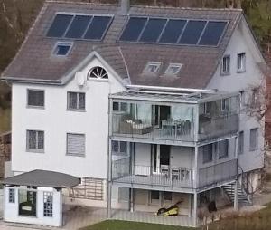 an aerial view of a house with solar panels on the roof at Ferien Im Toggenburg in Ebnat +3 photos