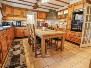 a large kitchen with a wooden table and chairs at Freshwinds in Market Drayton