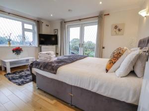 a bedroom with a large bed and a television at Freshwinds in Market Drayton +90 photos