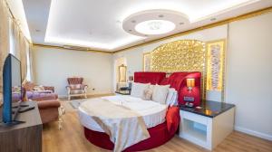a bedroom with a large bed and a living room at can palace adalya otel in Antalya +50 photos