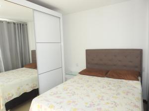 een slaapkamer met een bed en een grote witte kast bij Cobertura Maison dos Colibris in Arraial do Cabo +40 foto's