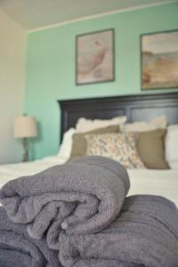 a blanket laying on top of a bed at 1-Bedroom Retreat Apt 3 in Bridgewater