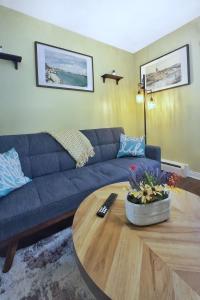 a living room with a blue couch and a coffee table at 1-Bedroom Retreat Apt 3 in Bridgewater