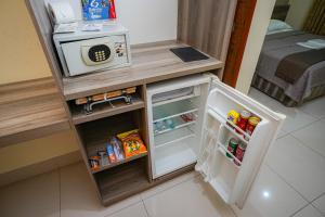 a small refrigerator with its door open in a room at Garcia Palace Hotel in Sinop