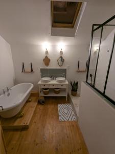 a bathroom with a white tub and a sink at Oxxy Casa - Gîte de 14 personnes in Milhas +27 photos
