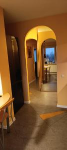 a hallway with an archway and a dining room at Ruola in Kaunas