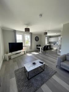 a living room with a couch and a table at Spacious Flat in Aberdeenshire in Insch