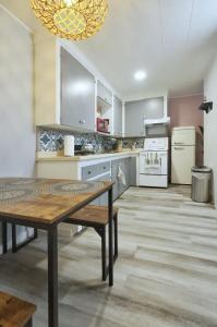 a large kitchen with a wooden table in it at 1BR Backyard Bliss - Apt 6 in Bridgewater