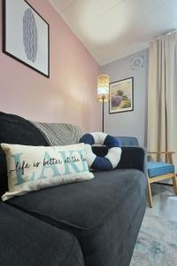 a couch with a pillow that says life is better at home at 1BR Backyard Bliss - Apt 6 in Bridgewater