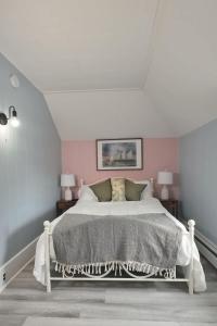a bedroom with a white bed with two lamps at Chic & Sunny 1BR Hideaway- Apt 1 in Bridgewater