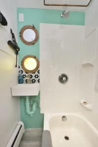 a small bathroom with a tub and a sink at Chic & Sunny 1BR Hideaway- Apt 1 in Bridgewater