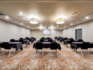 a conference room with tables and chairs and a screen at Holiday Inn Tacoma Mall by IHG in Tacoma +55 photos